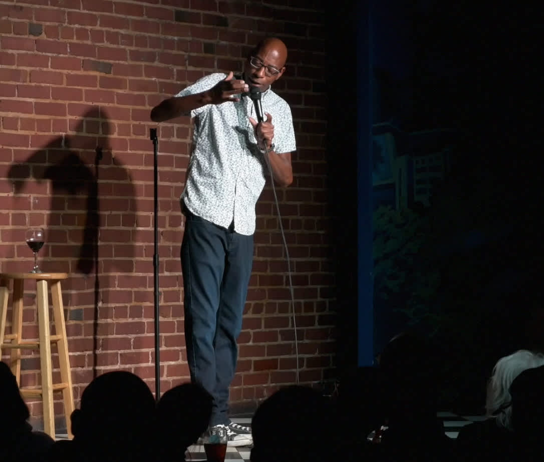 Mike Mello on stage performing his 2018 stand-up special Incognegro
